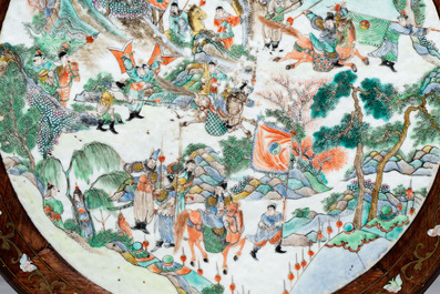 A Chinese mother-of-pearl-inlaid hongmu table with a circular Canton famille verte 'warriors on horseback' plaque, 19th C.