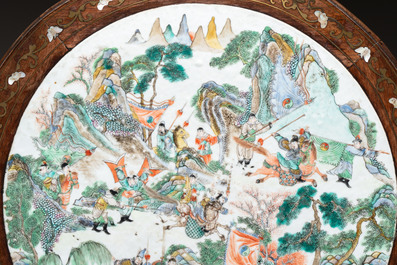 A Chinese mother-of-pearl-inlaid hongmu table with a circular Canton famille verte 'warriors on horseback' plaque, 19th C.