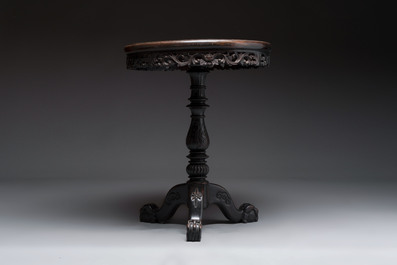 A Chinese mother-of-pearl-inlaid hongmu table with a circular Canton famille verte 'warriors on horseback' plaque, 19th C.