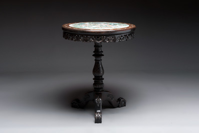 A Chinese mother-of-pearl-inlaid hongmu table with a circular Canton famille verte 'warriors on horseback' plaque, 19th C.