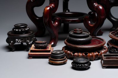 A collection of 30 Chinese wooden stands, 19/20th C.