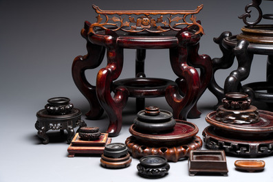 A collection of 30 Chinese wooden stands, 19/20th C.