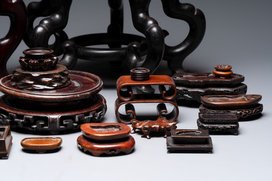 A collection of 30 Chinese wooden stands, 19/20th C.