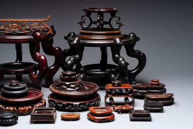 A collection of 30 Chinese wooden stands, 19/20th C.