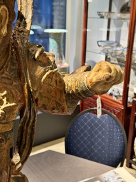 A large Chinese polychrome-lacquered wooden figure of a Guardian King, 18/19th C.