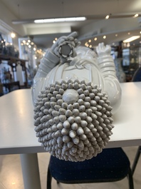 A large Chinese Dehua blanc de Chine figure of Buddha holding a lotus, He Chaozong 何朝宗 and Dehua 德化 mark, 20th C.