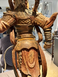 A large Chinese polychrome-lacquered wooden figure of a Guardian King, 18/19th C.