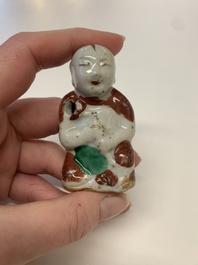 Two Chinese Dehua blanc de Chine Buddha and Wenchang figures, a seal paste covered box, a vase and an iron-red-glazed boy, Qianlong mark, 19/20th C.