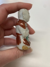 Two Chinese Dehua blanc de Chine Buddha and Wenchang figures, a seal paste covered box, a vase and an iron-red-glazed boy, Qianlong mark, 19/20th C.