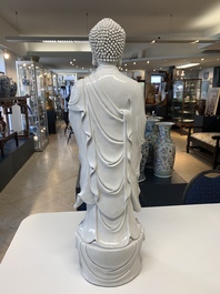 A large Chinese Dehua blanc de Chine figure of Buddha holding a lotus, He Chaozong 何朝宗 and Dehua 德化 mark, 20th C.