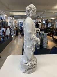 A large Chinese Dehua blanc de Chine figure of Buddha holding a lotus, He Chaozong 何朝宗 and Dehua 德化 mark, 20th C.