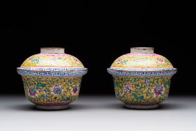 A pair of Chinese yellow-ground Canton enamel covered bowls and two cups, Yongzheng/Qianlong