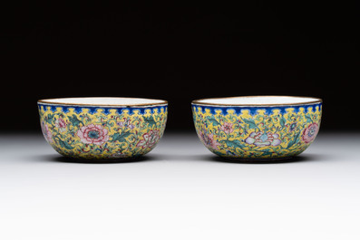 A pair of Chinese yellow-ground Canton enamel covered bowls and two cups, Yongzheng/Qianlong