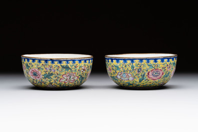 A pair of Chinese yellow-ground Canton enamel covered bowls and two cups, Yongzheng/Qianlong