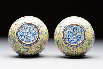 A pair of Chinese yellow-ground Canton enamel covered bowls and two cups, Yongzheng/Qianlong