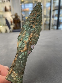 Four Chinese and Vietnamese bronze axes and an arrowhead, Western Zhou/Dong Son