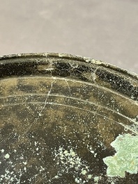 A bronze mirror, a bracelet with a royal or noble emblem and a bronze bracelet with two tiger heads, Cambodia, 12th C.