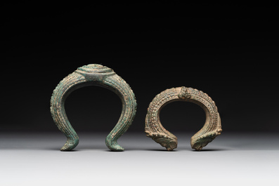 A bronze mirror, a bracelet with a royal or noble emblem and a bronze bracelet with two tiger heads, Cambodia, 12th C.