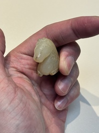 A Chinese white and russet jade pendant in the form of a horse, Song/Ming