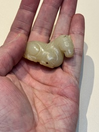 A Chinese white and russet jade pendant in the form of a horse, Song/Ming