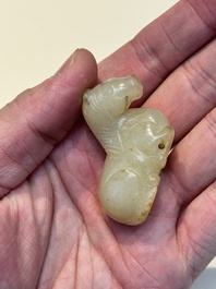 A Chinese white and russet jade pendant in the form of a horse, Song/Ming