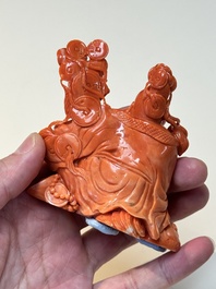 A Chinese red coral sculpture of a Milefo Buddha on wooden stand, 19/20th C.