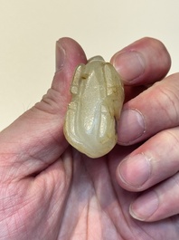 A Chinese white and russet jade pendant in the form of a horse, Song/Ming