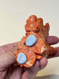 A Chinese red coral sculpture of a Milefo Buddha on wooden stand, 19/20th C.
