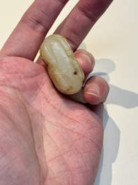 A Chinese white and russet jade pendant in the form of a horse, Song/Ming