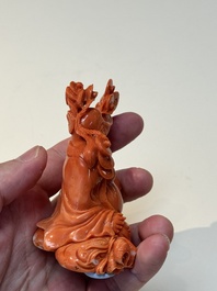 A Chinese red coral sculpture of a Milefo Buddha on wooden stand, 19/20th C.