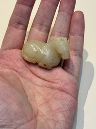 A Chinese white and russet jade pendant in the form of a horse, Song/Ming