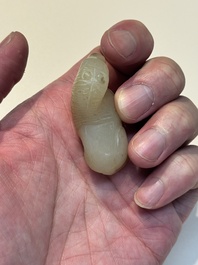 A Chinese white and russet jade pendant in the form of a horse, Song/Ming