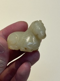 A Chinese white and russet jade pendant in the form of a horse, Song/Ming