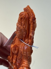 A fine Chinese red coral sculpture of Guanyin seated on a lotus throne on a wooden stand, 19/20th C.
