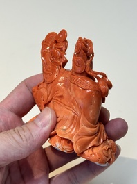 A Chinese red coral sculpture of a Milefo Buddha on wooden stand, 19/20th C.
