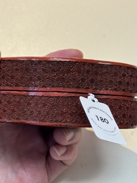 A fine Chinese red cinnabar lacquer ruyi-form 'Ba Man Xian Bao 八蠻獻寶' box and cover, Qianlong