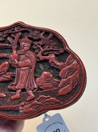 A fine Chinese red cinnabar lacquer ruyi-form 'Ba Man Xian Bao 八蠻獻寶' box and cover, Qianlong