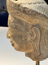 A Khmer Angkor Wat-style sandstone head of Shiva, probably 12th C.