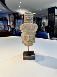 A Khmer Angkor Wat-style sandstone head of Shiva, probably 12th C.