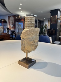 A Khmer Angkor Wat-style sandstone head of Shiva, probably 12th C.