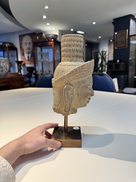 A Khmer Angkor Wat-style sandstone head of Shiva, probably 12th C.