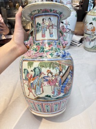 A pair of Chinese famille rose vases with narrative design on wooden stands, 19th C.
