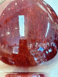 A large Chinese flamb&eacute;-glazed 'yuhuchunping' vase on a wooden stand, 19th C.