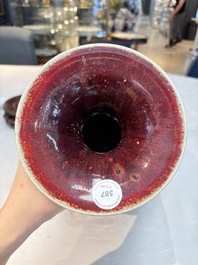 A large Chinese flamb&eacute;-glazed 'yuhuchunping' vase on a wooden stand, 19th C.