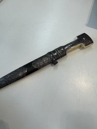 A Caucasian walrus bone-hilted kindjal with niello silver mounts, 19th C.