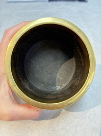 A Chinese bronze cylindrical tripod censer, Xuande mark, 18th C.