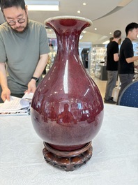 A large Chinese flamb&eacute;-glazed 'yuhuchunping' vase on a wooden stand, 19th C.
