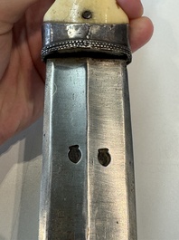 A Caucasian walrus bone-hilted kindjal with niello silver mounts, 19th C.