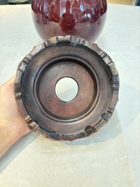 A large Chinese flamb&eacute;-glazed 'yuhuchunping' vase on a wooden stand, 19th C.