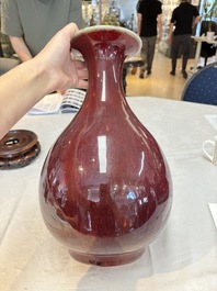 A large Chinese flamb&eacute;-glazed 'yuhuchunping' vase on a wooden stand, 19th C.
